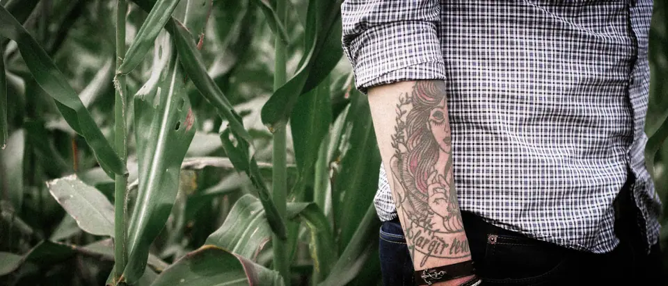 Tatuaje tipo manga visible en el antebrazo