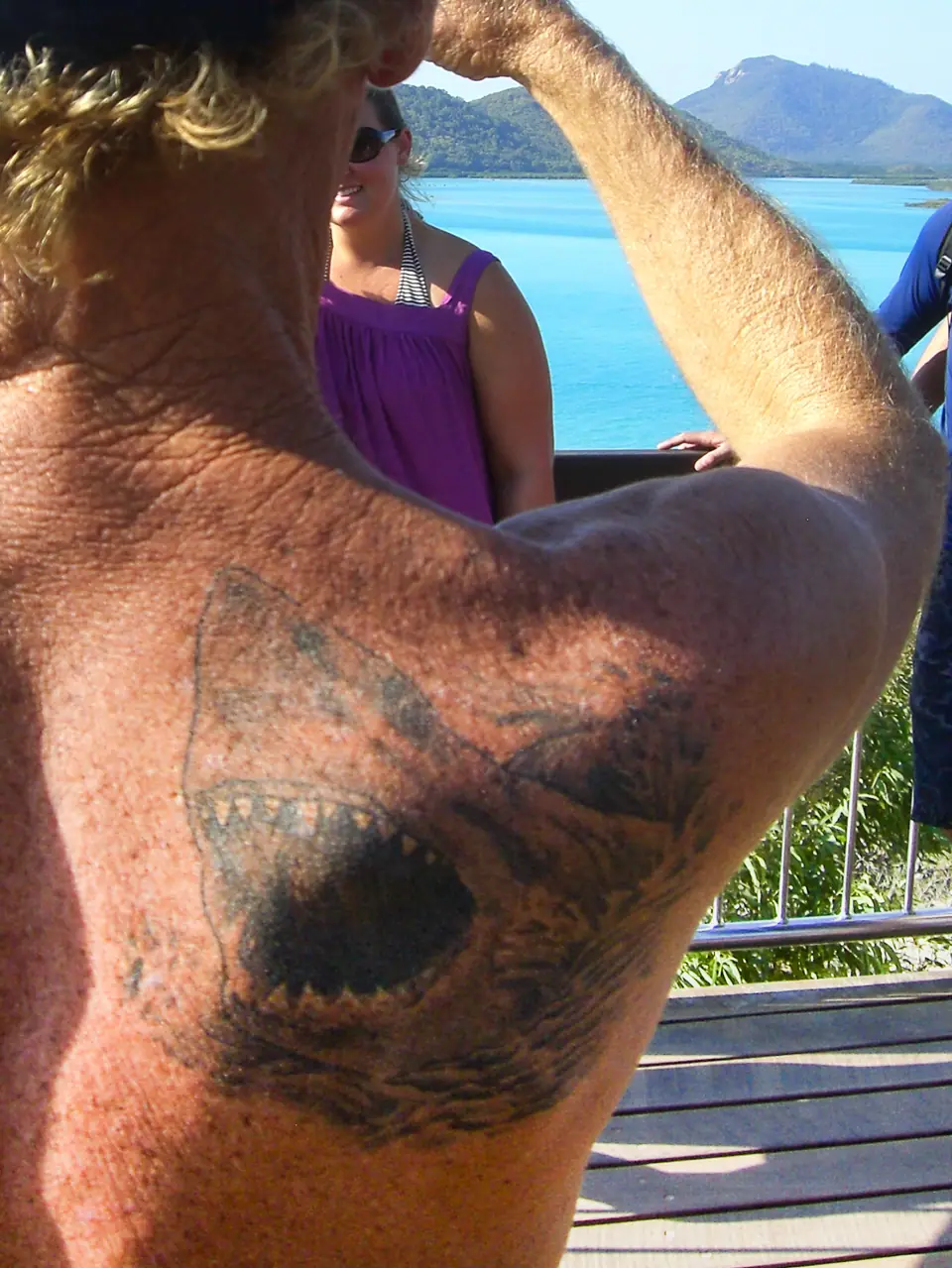 Tatuaje de una cabeza de tiburón con las fauces abiertas, en el hombro